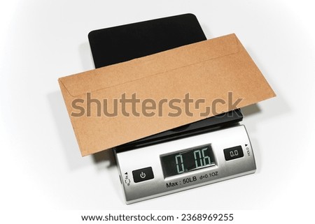 An electronic scale for weighing a parcel or letter. Royalty-Free Stock Photo #2368969255