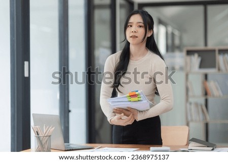 Asian businesswoman working with document papers at work in office, Checking financial papers.