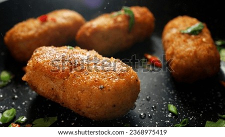 The cooking process. Stock footage. Frying meat cutlets with vegetables in hot pans.