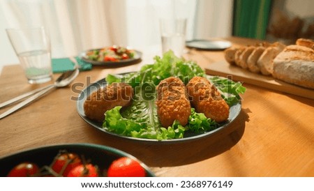 Dining table with cutlets. Stock footage. Beautiful homemade lunch with healthy dishes. Healthy lunch with cutlets and greens on sunny day at home