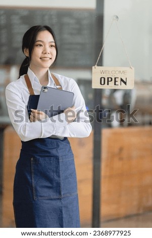 Happy smelling Asian woman owner with open sign broad and ready to service, cafe owner, Small startup business concept.
