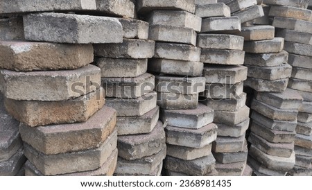 pile of red and gray rectangular cornblock stones