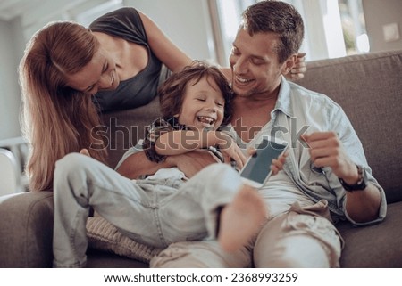 Young family bonding and having fun on the couch at home
