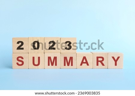 Year 2023 review and summary concept. Wooden blocks typography in blue background.