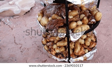 Traditional Jordanian food at Bedouin Desert Camp in Wadi Rum Protected Area, Jordan. Royalty-Free Stock Photo #2369010117