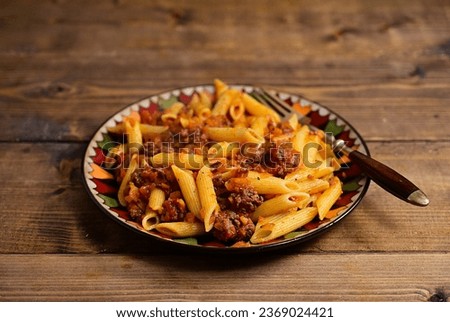 Plate penne with meat sauce.