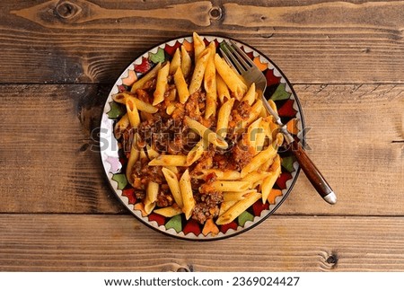 Plate penne with meat sauce.