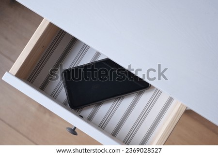 mobile phone in open drawer. Royalty-Free Stock Photo #2369028527