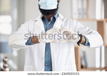 Doctor, hands and heart sign with mask for safety, healthcare and cardiology icon in hospital. Medic man, emoji and ppe gloves for wellness, kindness or medical support with review for clinic service