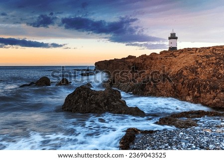 Sunset over Penmon Point lighthouse near Beaumaris on the Anglesey coast in north Wales