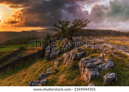 Stormy sunset over a small limestone pavement at the Winskill Stones near Settle in the Yorkshire Dales Royalty-Free Stock Photo #2369044501