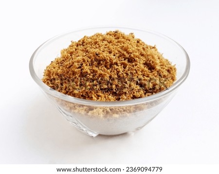 The refined fish floss or shredded fish. Made from tuna fish. Served on a small glass bowl and isolated on a white background. Royalty-Free Stock Photo #2369094779