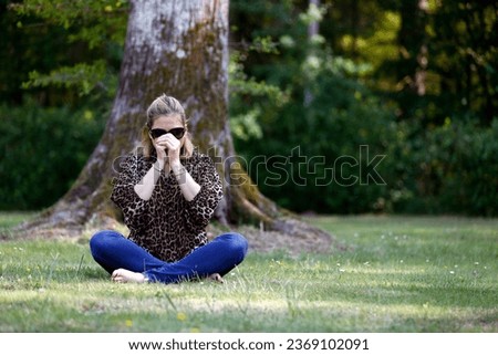 Christian woman  spending personal time in and  praying outdoors in a park. 