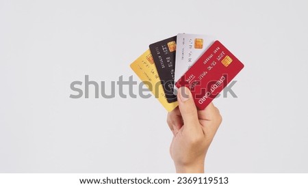 Hand is hold four credit cards on white background. Royalty-Free Stock Photo #2369119513
