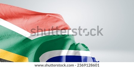 South Africa national flag cloth fabric waving on beautiful grey light Background.