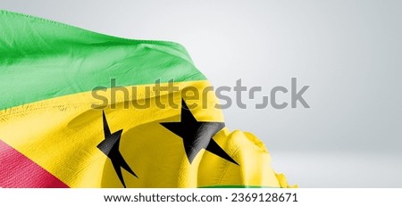 Sao Tome and Principe. national flag cloth fabric waving on beautiful grey light Background.