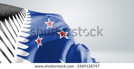 New Zealand national flag cloth fabric waving on beautiful grey light Background.