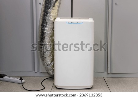 Portable air conditioner with heat removal pipe Royalty-Free Stock Photo #2369132853