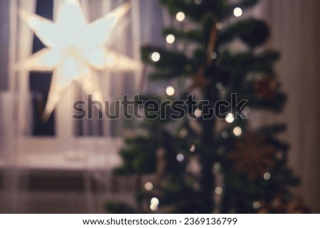 Blurred background of the home was transformed into a winter wonderland for Christmas, with sparkling lights and festive ornaments.