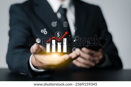 Businessman analyzes financial growth charts, plans marketing strategies and keeps statistics on increasing income. business management concept.