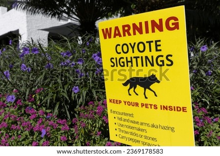 Sign warning about coyotes in a suburban neighborhood Royalty-Free Stock Photo #2369178583