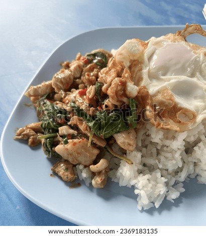 a photography of a plate of food with rice and a fried egg, there is a plate of food with rice and a fried egg.