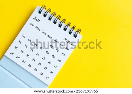 August 2024 table calendar on yellow cover background with customizable space for text.