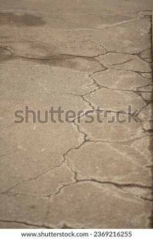 Old tiles showing cracked hexagons on the asphalt in the park