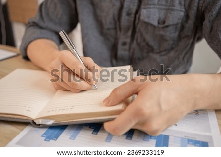 Taking note, Young Man's Hand Writing an Important Message in Notebook - Communication, Take notes of important messages. Royalty-Free Stock Photo #2369233119