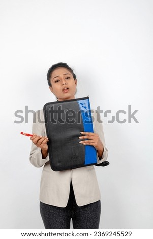 Corporate office lady holding a folder and giving presentation. Young woman in formal wear wearing white blazer against white background. 
