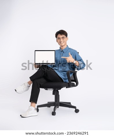 Full body of young Asian man using laptop on white background