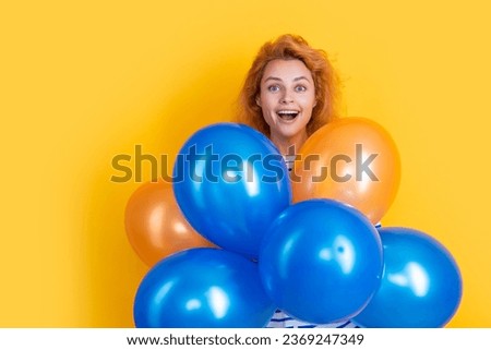 happy birthday girl hold balloons in studio. amazed girl with balloon for birthday party isolated on yellow background. birthday party girl