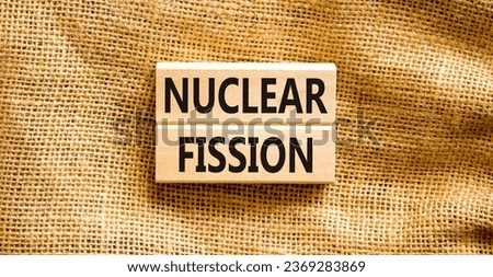 Nuclear fission symbol. Concept words Nuclear fission on beautiful wooden blocks. Beautiful canvas table canvas background. Business science nuclear fission concept. Copy space. Royalty-Free Stock Photo #2369283869