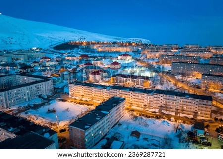 Night citycape of Kirovsk. Houses in evening illumination. Polar city in winter. (Kirovsk, Russia, Murmansk Oblast, Kola Peninsula, known as Khibinogorsk, cold winter weather) Royalty-Free Stock Photo #2369287721