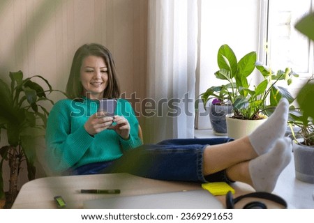 Happy young woman rejoicing over victoring on internet, completing project, done or new job, success, winning online lottery, finishing mortgage. Female millennial glad at computer in home office  Royalty-Free Stock Photo #2369291653