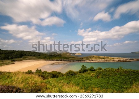Beautiful Scenic shell beach and sea print in summer at low tide Ards forest park and nature reserve in county Donegal on the wold Atlantic way in Ireland.  With blue skies and light cloud.