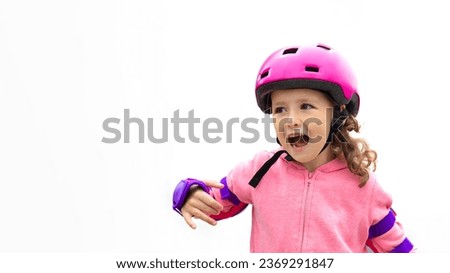 Portrait little cute girl rollerblading in purple protection, pink helmet in the city on white background. Child roller skating. Female in inline skates. Active sport kids. banner, copy space, text