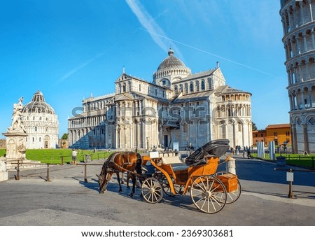 Carriage with horse in front of the leaning tower of Pisa Royalty-Free Stock Photo #2369303681