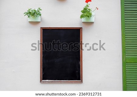 Restaurant black board or menu hanging on a wall. Mock-up space for text