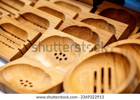 Various wooden soap dishes with drain holes and in different shapes Royalty-Free Stock Photo #2369322913