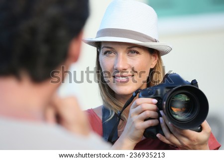 Portrait of woman photographer guiding model