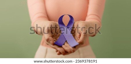 Cancer Awareness Campaign Concept. Global Healthcare. World Cancer Day. Close up of a Young Female Holding a Violet Ribbon into the Front. 