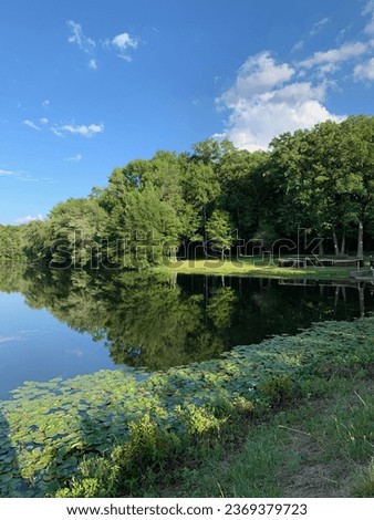 The Buddy Attic park on a beautiful summer afternoon with the lake reflecting perfectly as it is so calm.  Royalty-Free Stock Photo #2369379723
