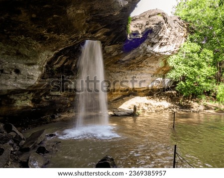 Saeng Chan waterfall in the deep humid forest at Ubon Ratchathani, Thailand, Leaf moving low-speed shutter blur. Royalty-Free Stock Photo #2369385957
