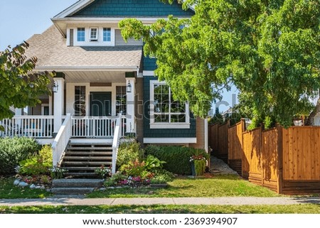 Real Estate Exterior Front House on a sunny day. Big custom made luxury house with nicely landscaped front yard in suburbs in a summer. Modern designed home, Two story modern home exterior Royalty-Free Stock Photo #2369394907