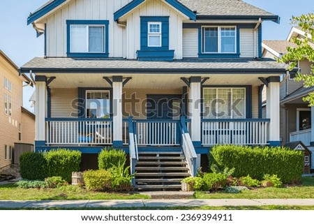 Real Estate Exterior Front House on a sunny day. Big custom made luxury house with nicely landscaped front yard in suburbs in a summer. Modern designed home, Two story modern home exterior Royalty-Free Stock Photo #2369394911