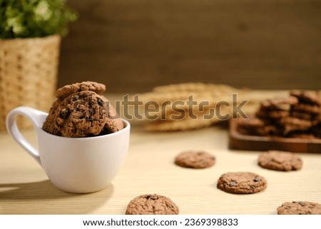 Homemade Chocolate Chip Cookies above Wooden Table, Served with a Bottle of Milk. Bakery Concept with Copy Space for Text.