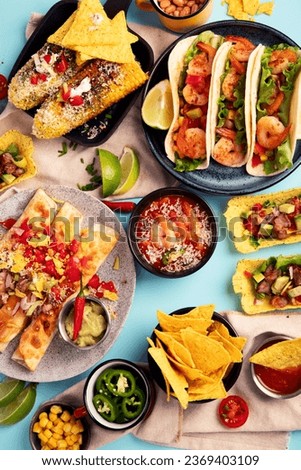 Mexican food, many dishes of the cuisine of Mexico on a blue background. Top view.