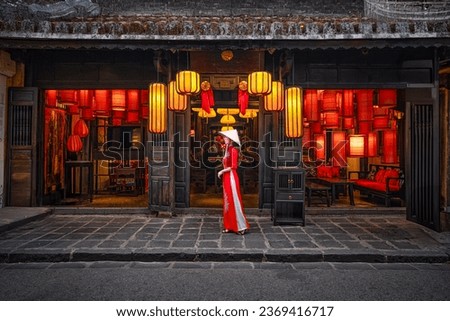 Tourists in traditional Vietnamese clothing look at  lanterns in Hoi An ancient town. Traditional Vietnamese culture and lanterns at Hoi An ancient city Vietnam Royalty-Free Stock Photo #2369416717