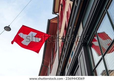 Swiss Flag hanging from Building facade in Basel, Switzerland